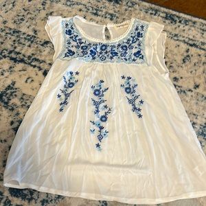 White blouse with blue floral detail. NWT. Size s